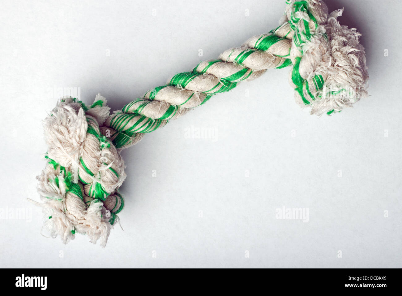 Knotted rope dog toy on white surface Stock Photo
