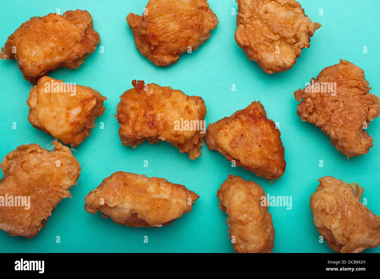 Boneless chicken wings on teal surface Stock Photo