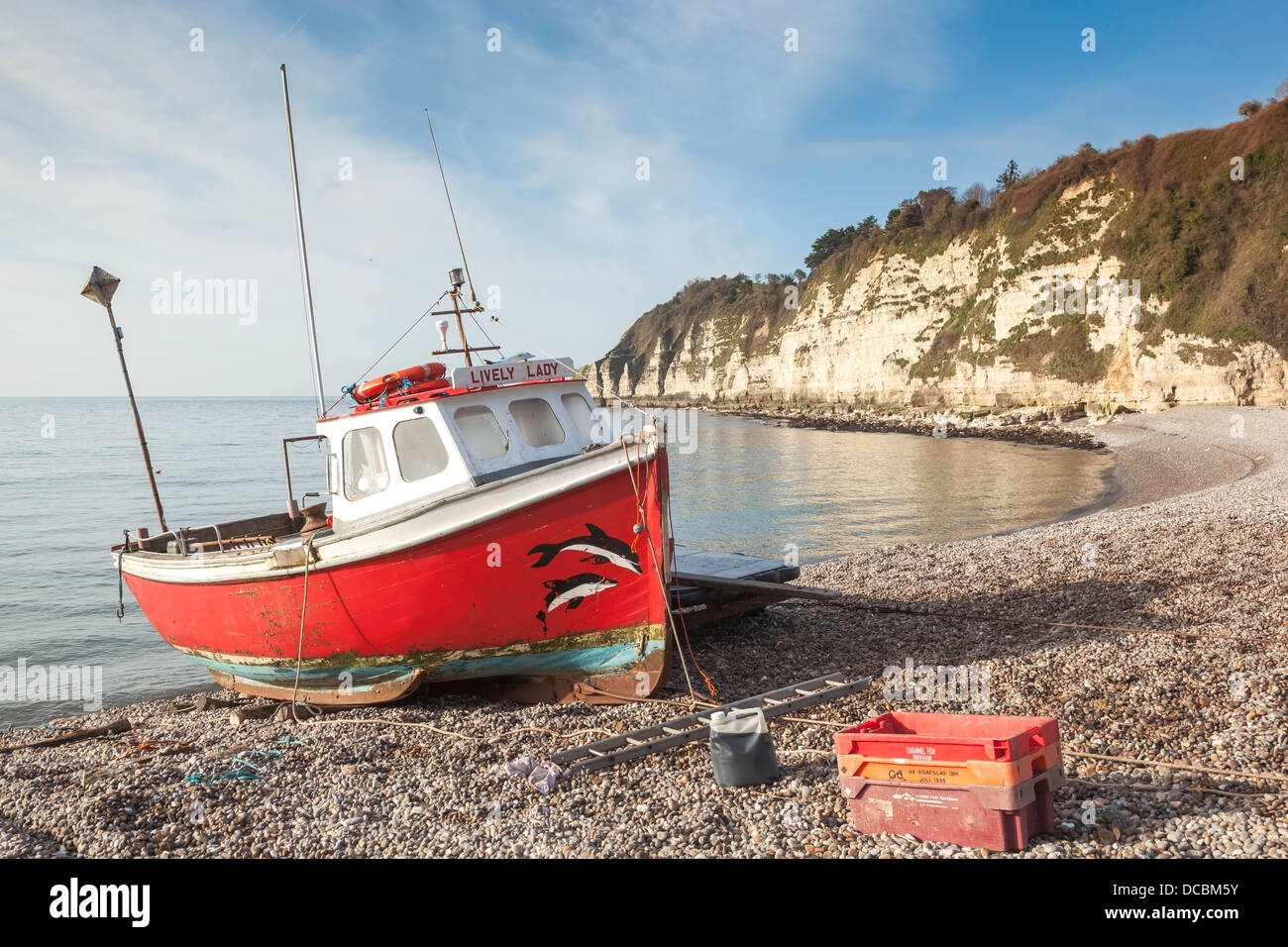 Lone fishing boat on the pebbly beach at Beer, Devon Stock Photo Alamy