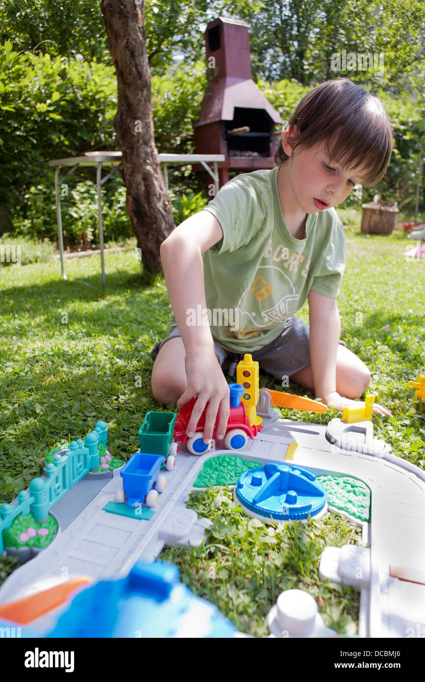 Boy playing garden grass hi-res stock photography and images - Alamy