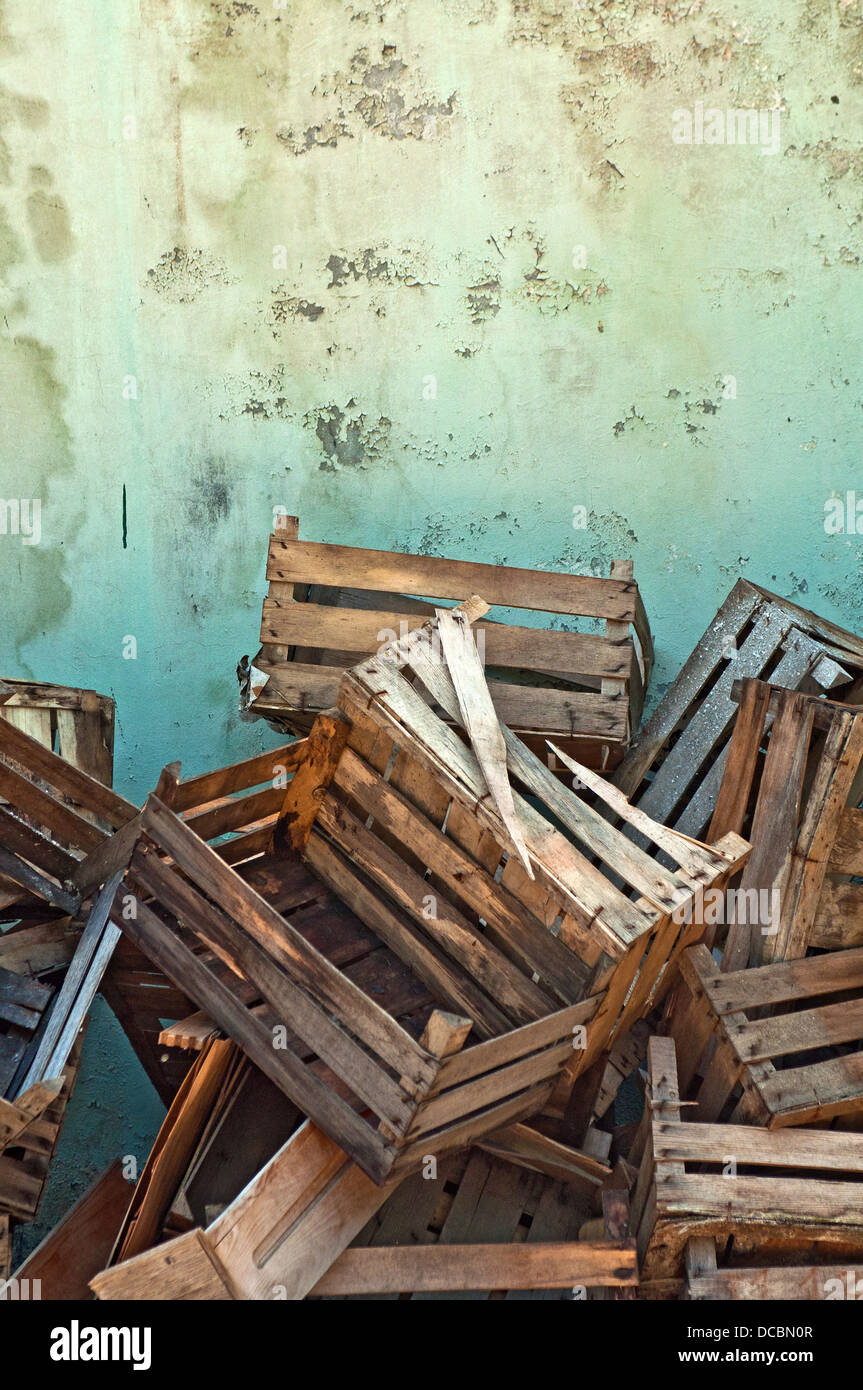 Wooden crates. Pile of old wooden crates against the wall Stock Photo