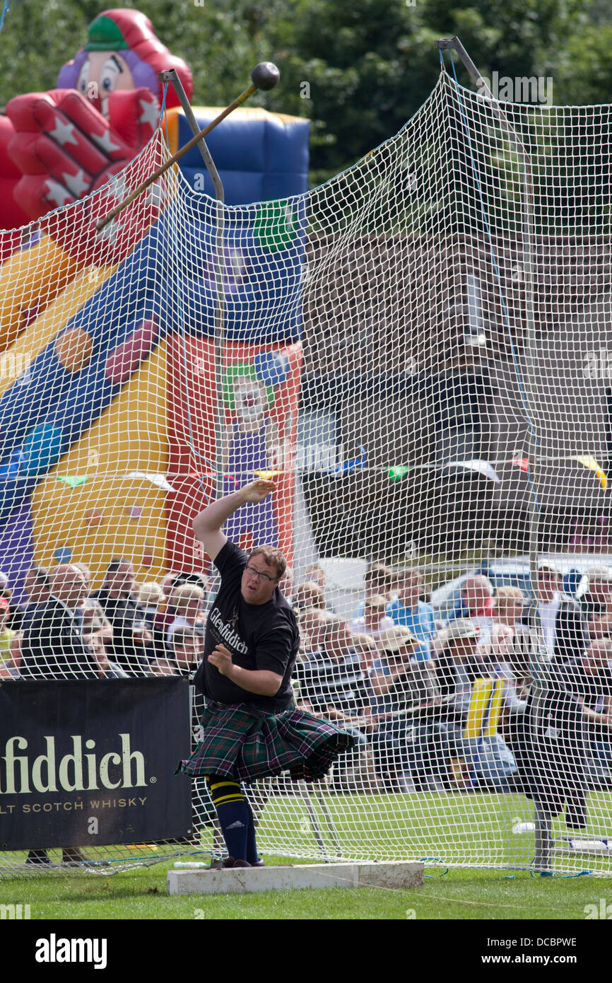 Ballater, Scotland - August 8th 2013: A competitor performing the hammer throw at the Ballater Highland Games. Stock Photo