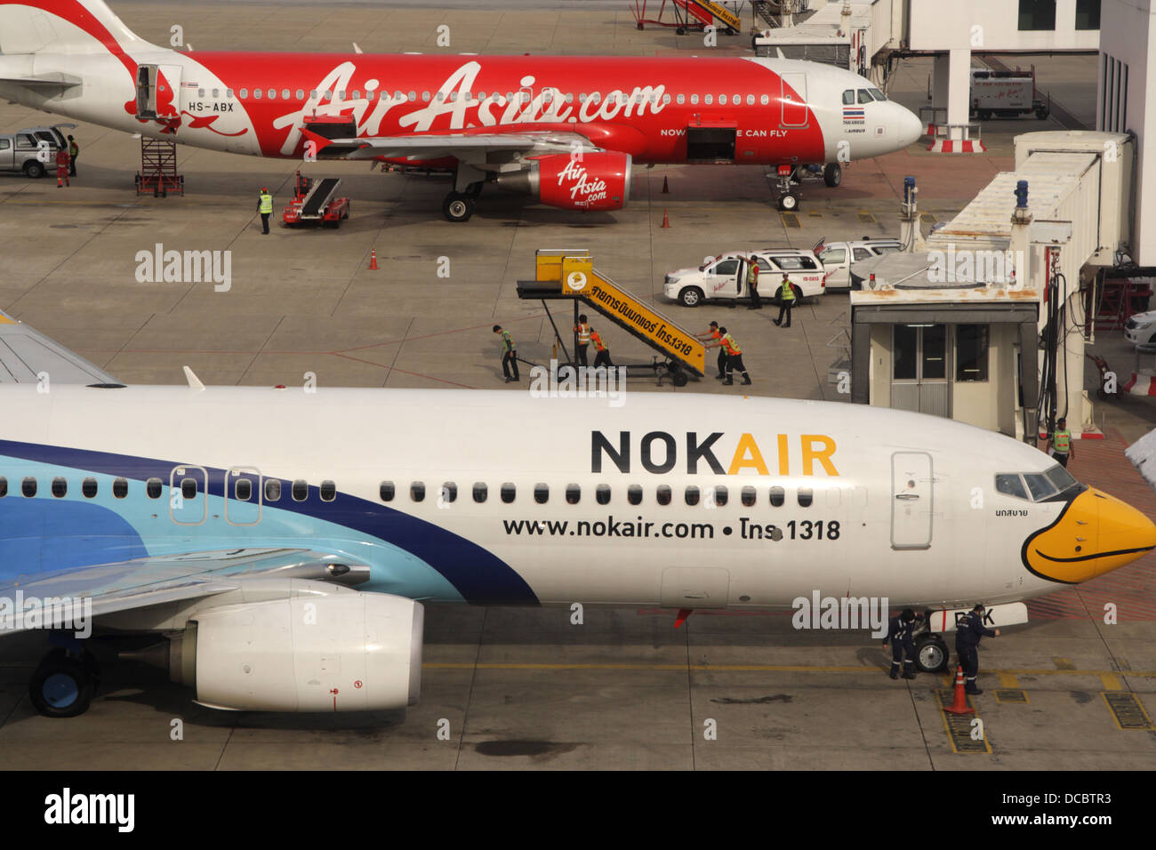 Low cost airline Nok Air parking near Air Asia plane at Don Muang airport Stock Photo