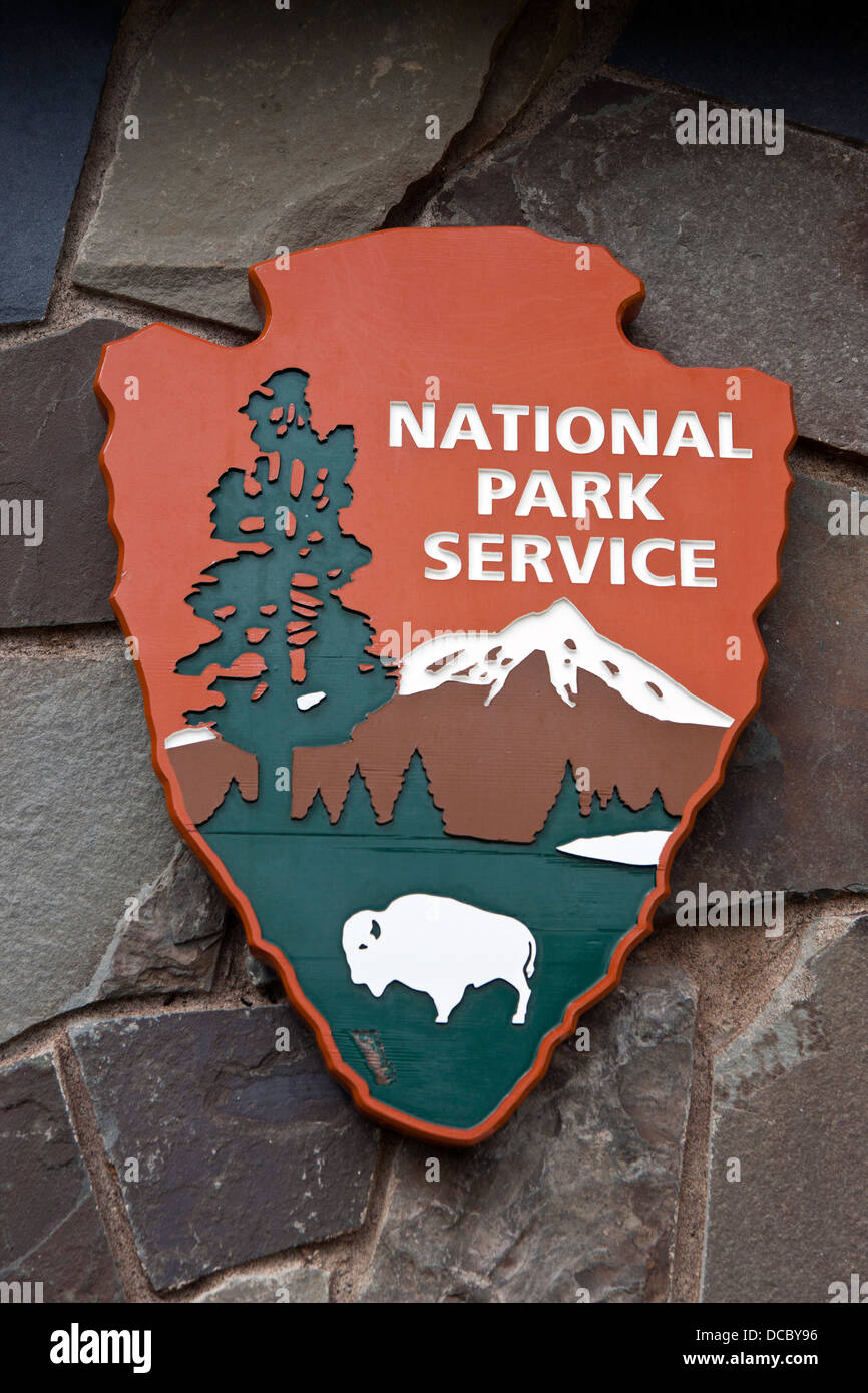 National Park Service logo shield on a rock wall, Grand Portage National Monument, Grand Portage, Minnesota, United States of America Stock Photo