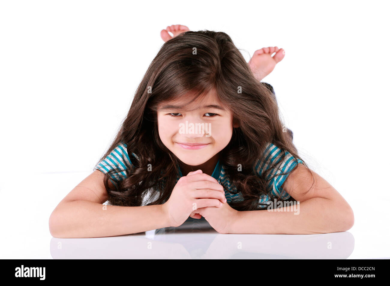 Happy little girl lying on floor Stock Photo - Alamy