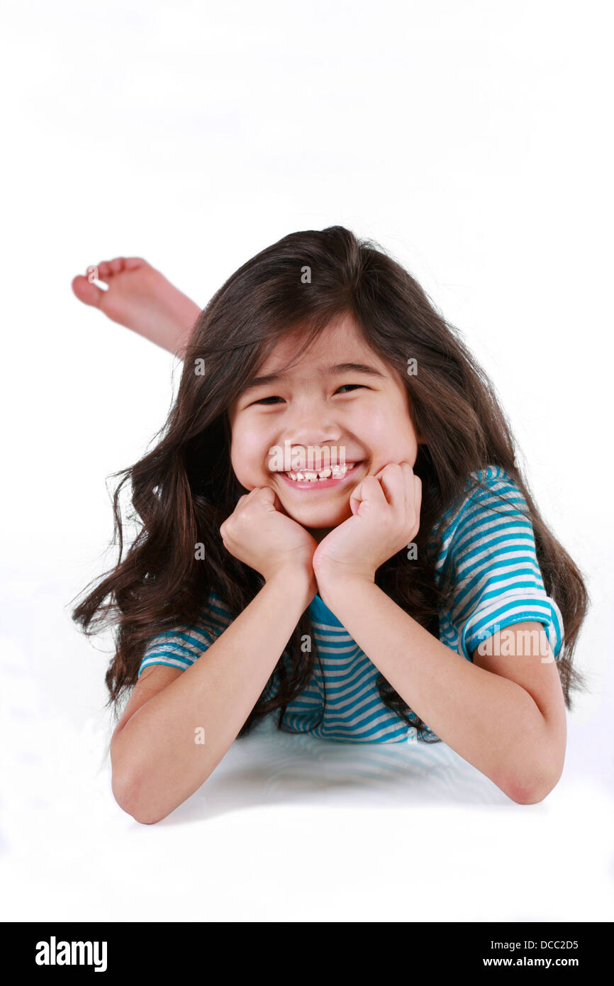 Happy little girl lying on floor Stock Photo - Alamy