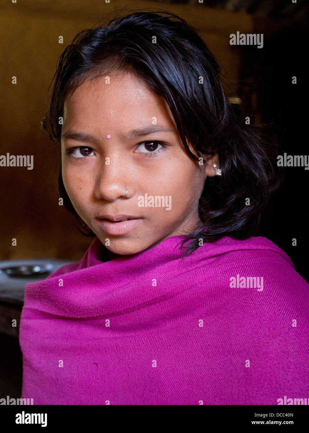 Young girl wearing a handmade pink pashmina in a Tharu village in the