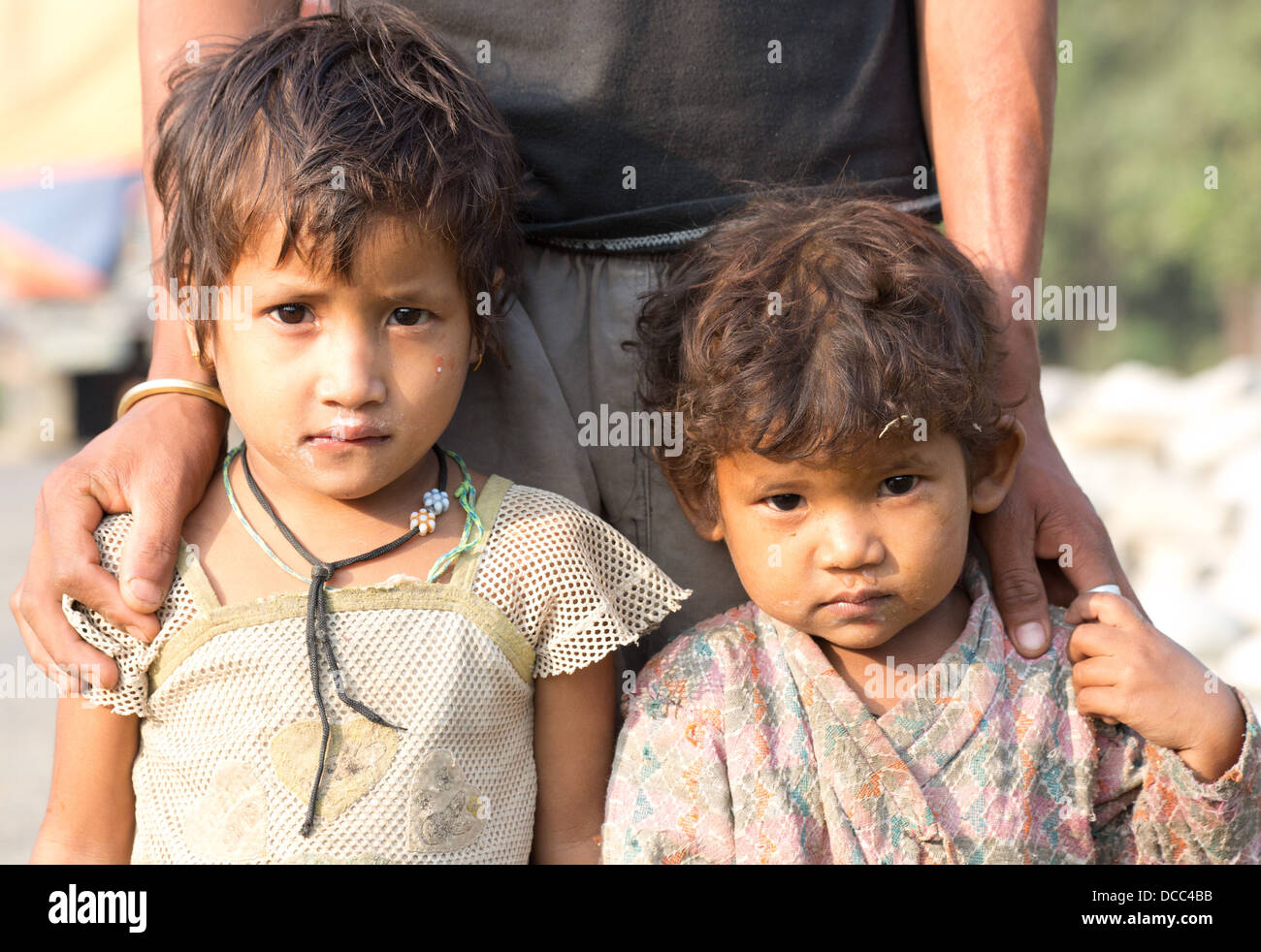 Two little children from a poor family, look sad and destitute and wearing  dirty clothes, Nepalganj, Nepal Stock Photo - Alamy