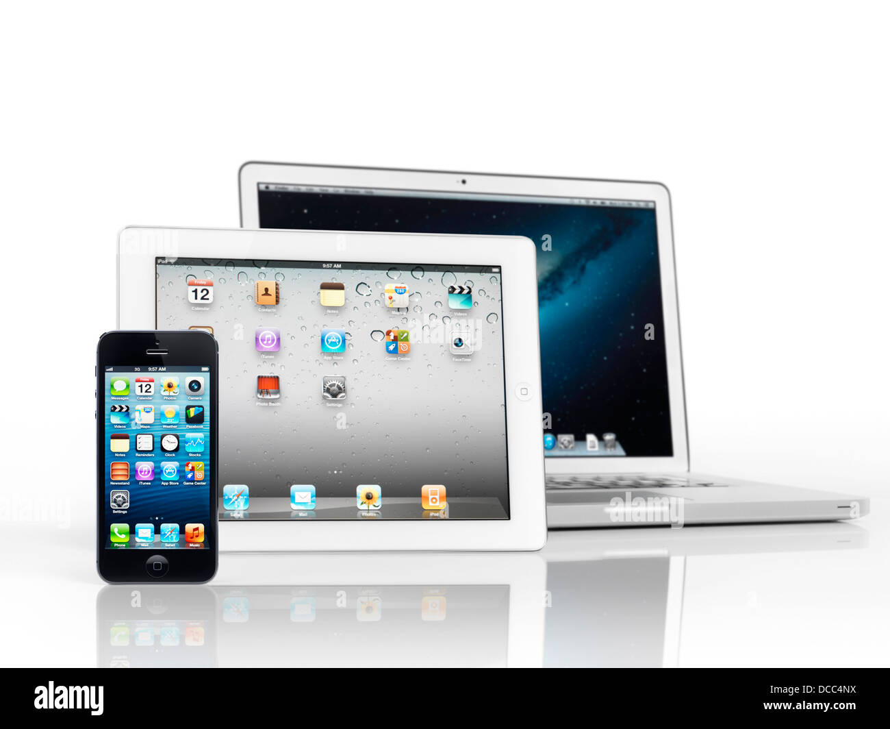 Electronics still life of three Apple devices, iPhone, iPad and Macbook Pro, smartphone, tablet and laptop computer, isolated Stock Photo