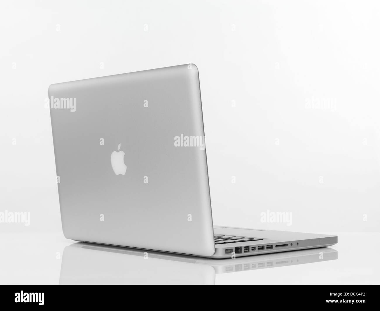 Macbook Pro laptop computer rear view with Apple logo on the lid isolated on white background Stock Photo