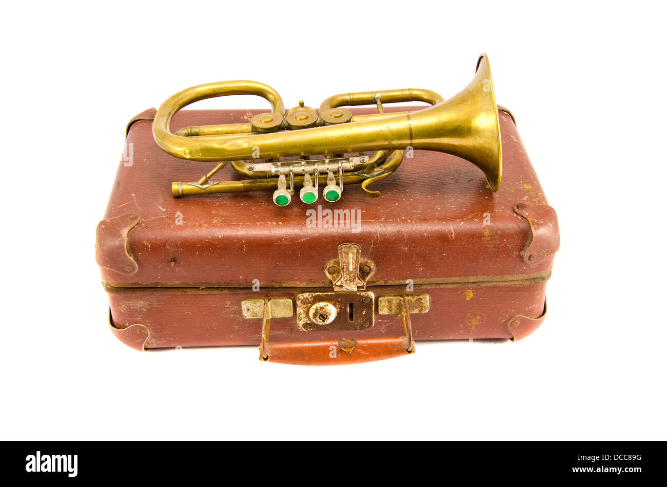 old brown suitcase for traveling and vintage brass musical instrument