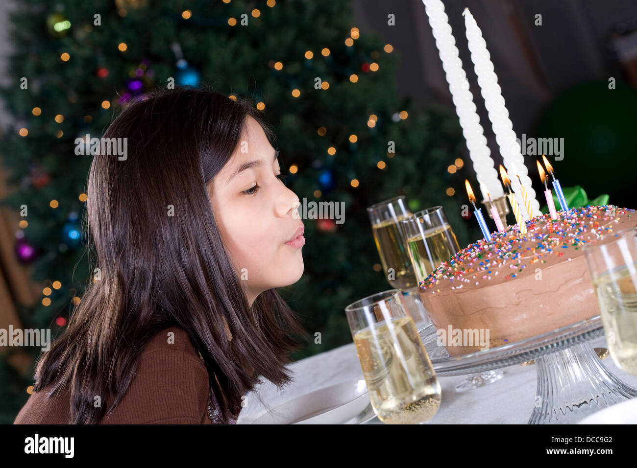 Little girl blowing out birthday candles Stock Photo Alamy