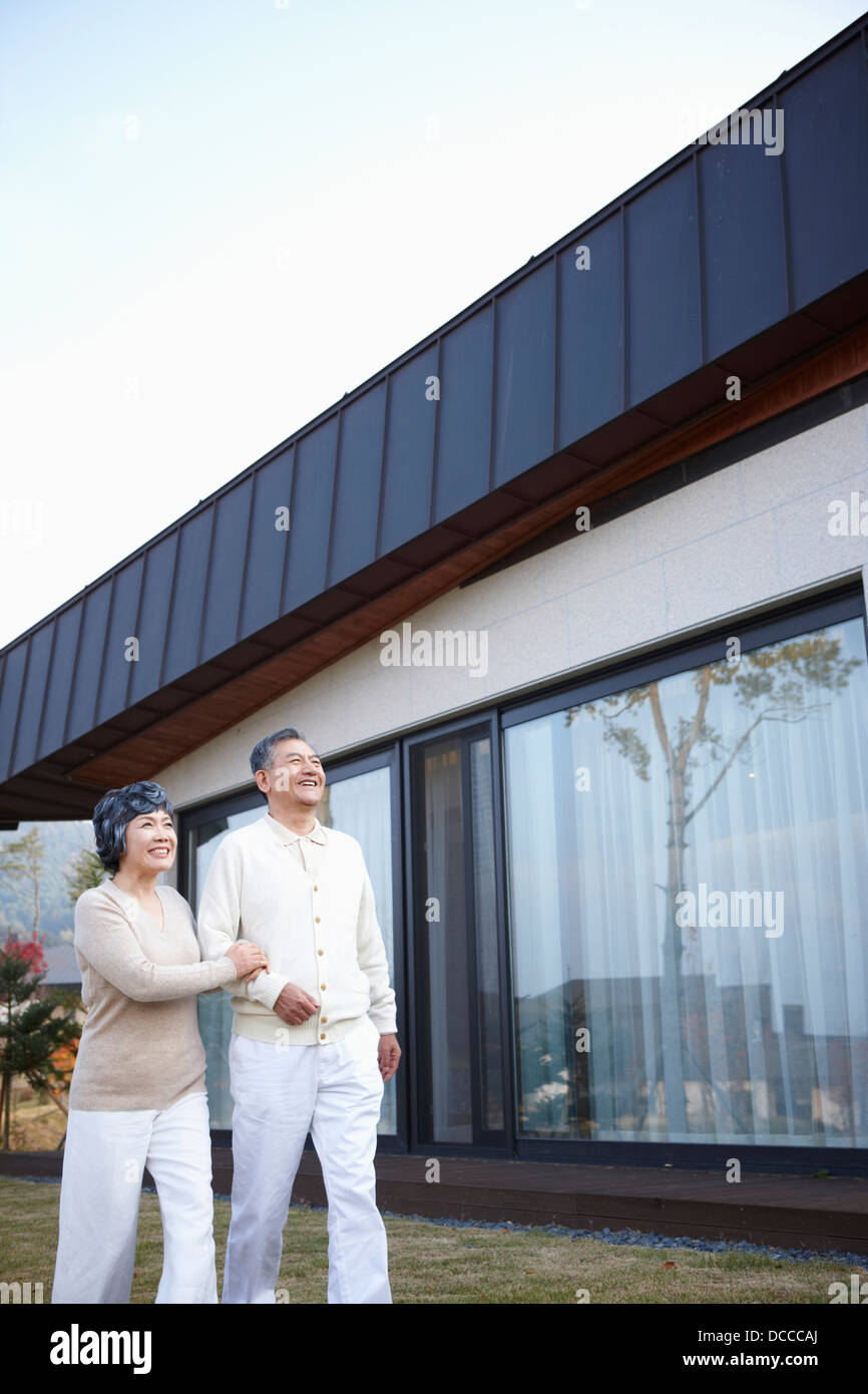 middle aged couple walking on a garden in front of house Stock Photo ...