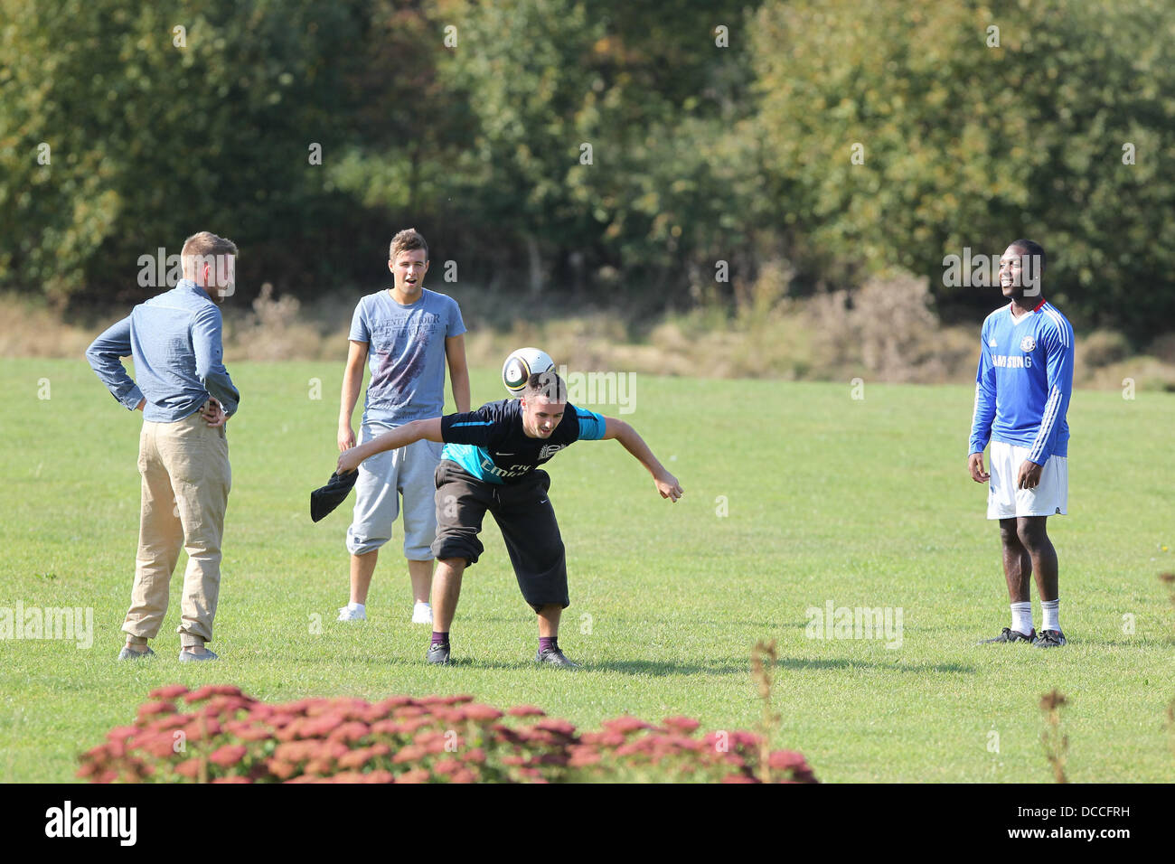 X Factor Finalists Jonjo Kerr, Andrew Merry, Charlie Healy and Derry Mensah  play football outside the X Factor house  England - 03.10.11 Stock Photo