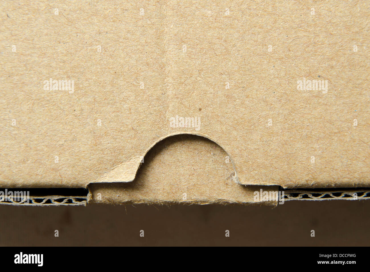 fragment of closed cardboard box with focus on lock Stock Photo