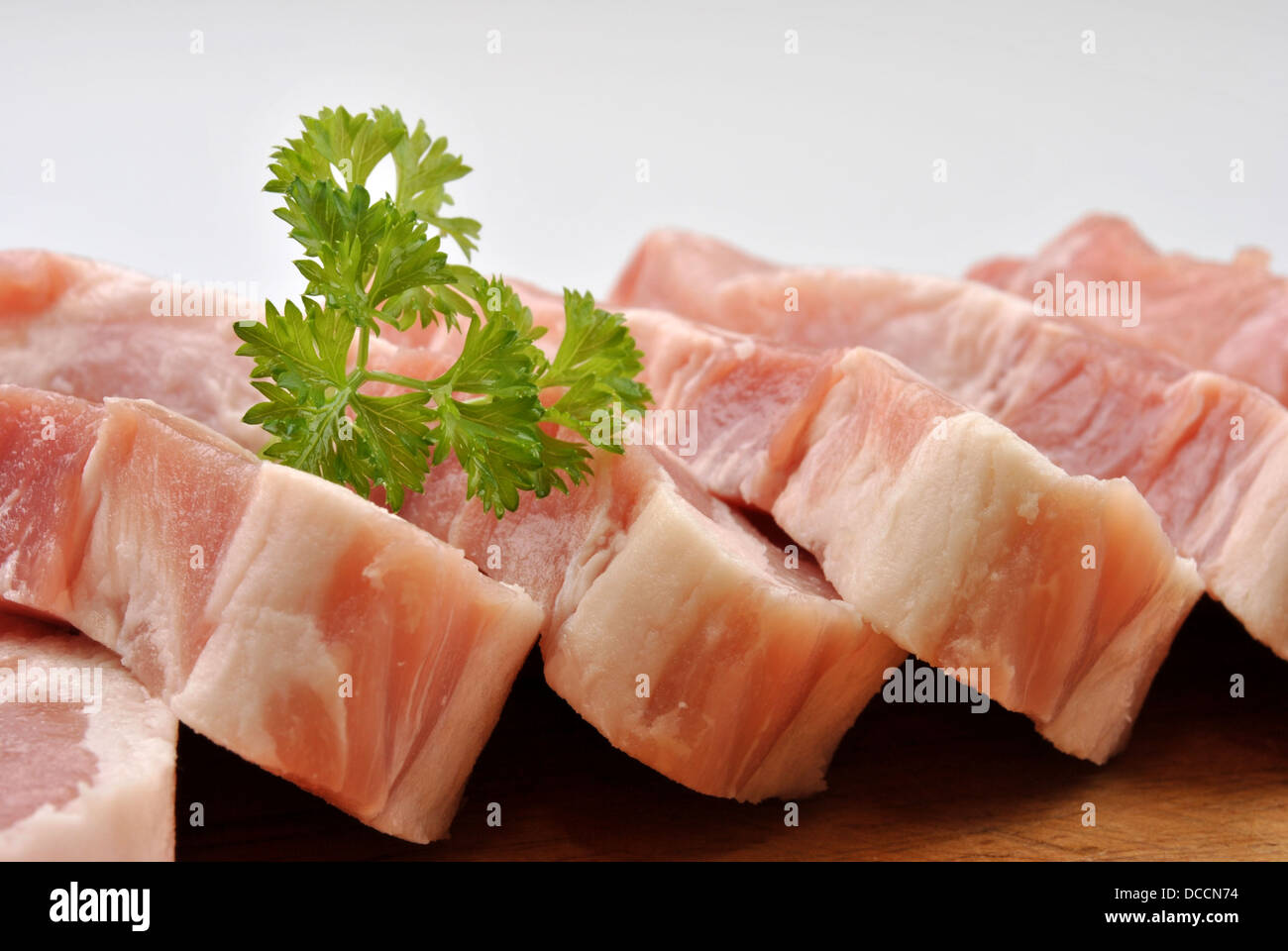 some raw organic pork chop and parsley Stock Photo