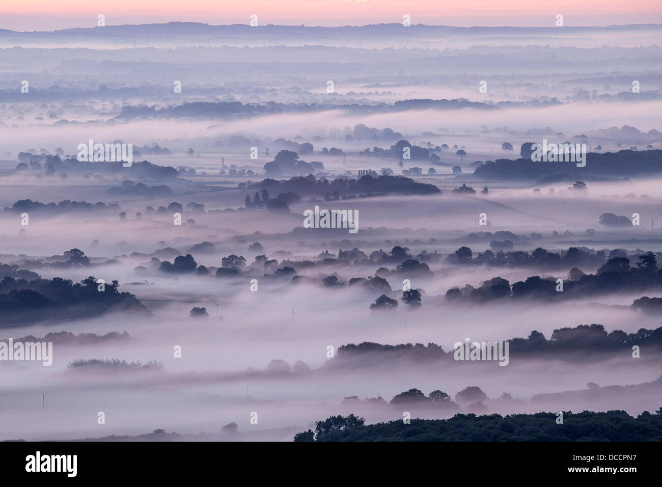 Sussex Weald, UK. 14th August 2013. Mist Envelopes the Sussex Weald Beneath Firle Beacon Credit:  Timothy Smith/Alamy Live News Stock Photo