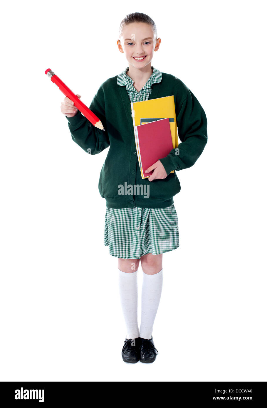 Full length portrait of blonde school girl holding big red pencil and ...