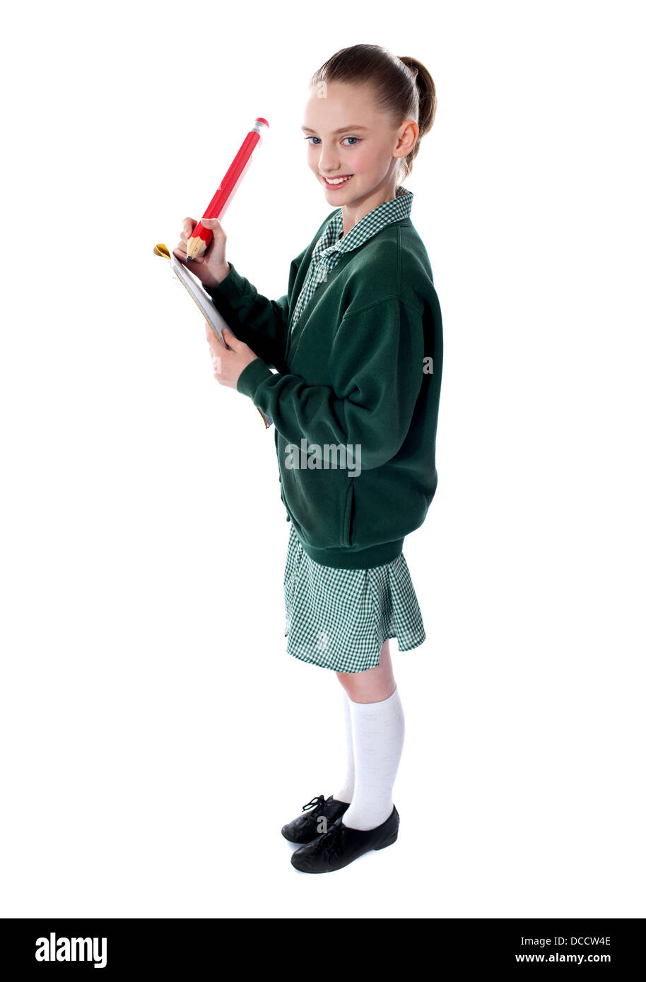 Side view of a school girl drawing with big pencil Stock Photo - Alamy