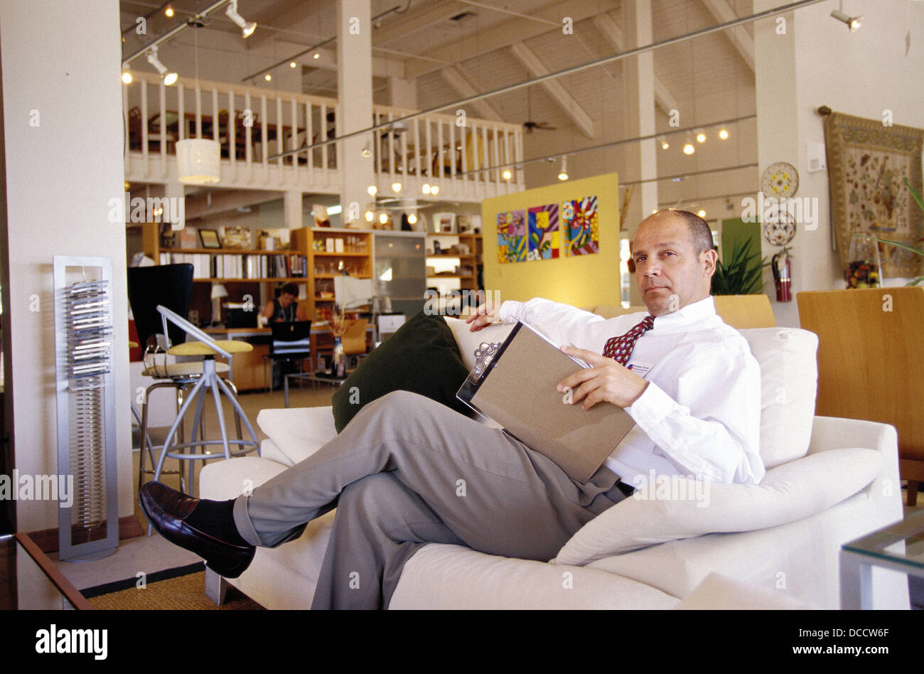 Salesman in furniture shop Stock Photo Alamy