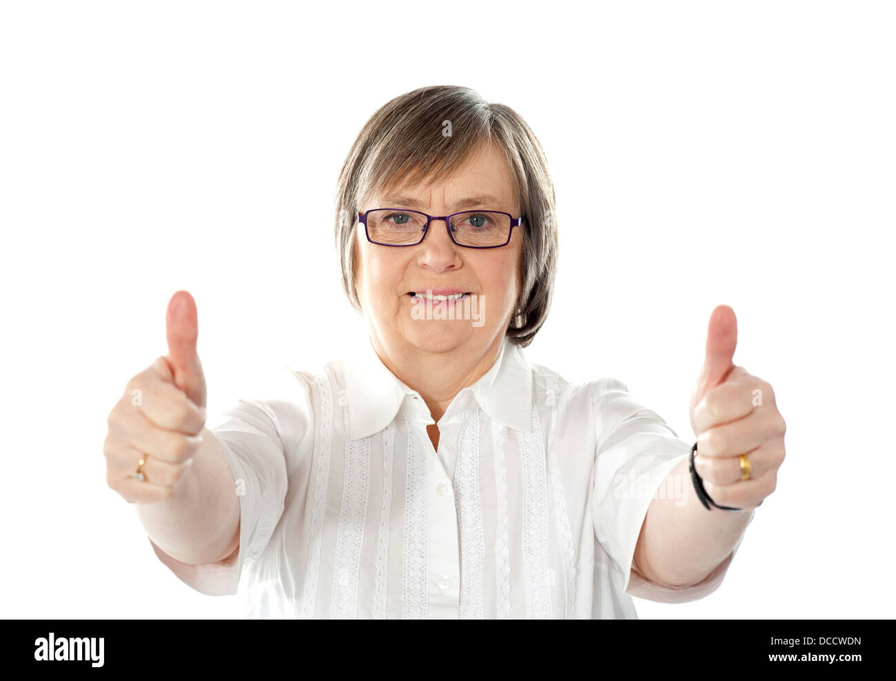 Female gesturing double thumbs up to camera isolated over white Stock