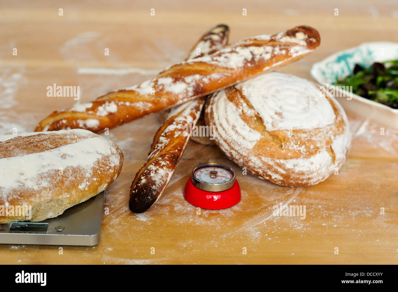 Baguettes and breads on wooden table. Closeup shot Stock Photo