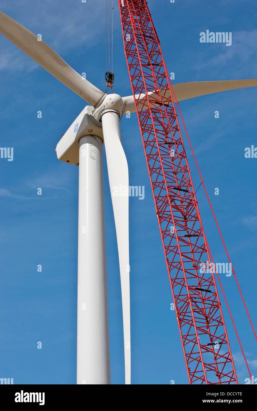 Crane boom and wind turbine, rotor is being lifted into position on