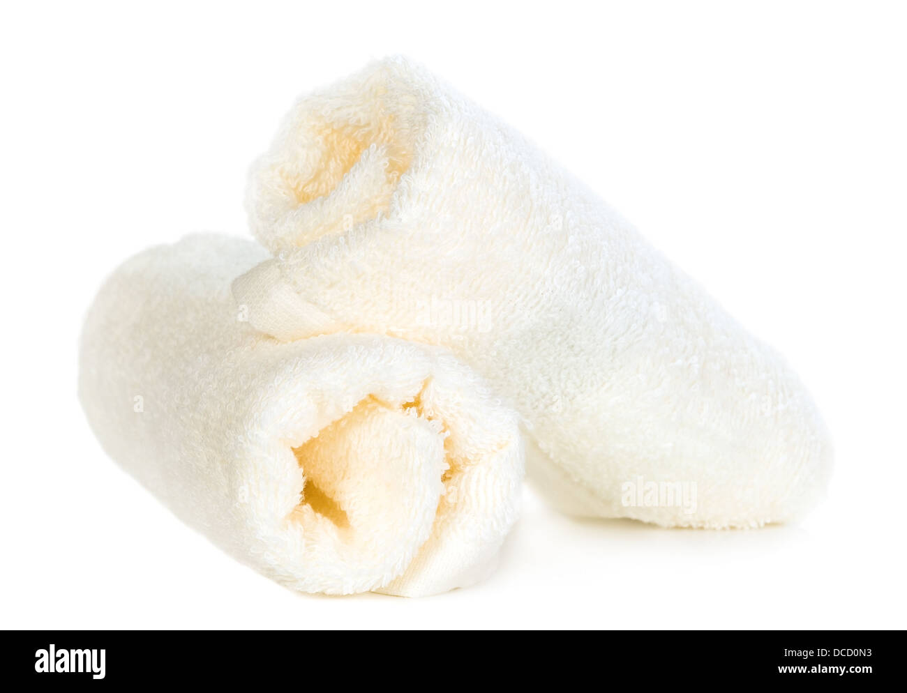 Rolled up white towels on isolated background Stock Photo