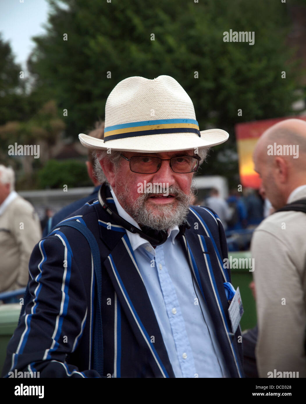 A cricket fan wearing a blazer and panama hat Stock Photo