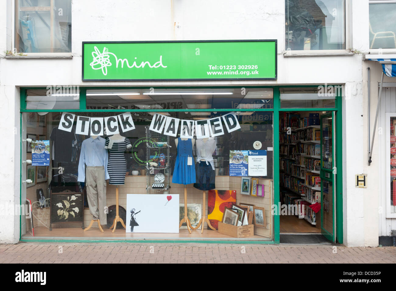 Mind Charity Shop Cambridge UK with stock wanted sign in the window