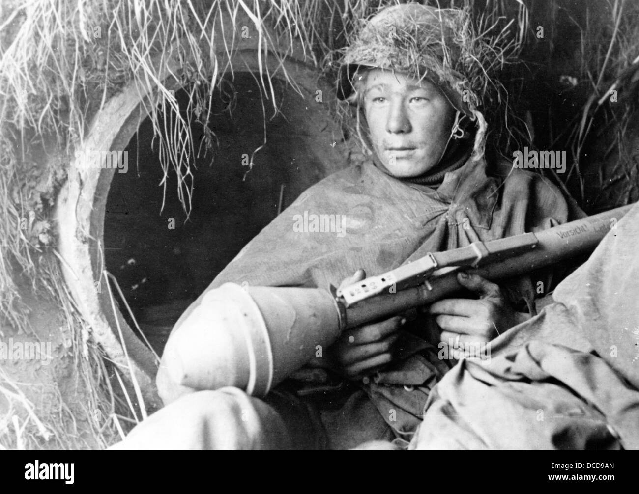 A member of the German Wehrmacht with a panzerfaust (anti-tank warhead) takes cover on the German Western Front in October 1944. Fotoarchiv für Zeitgeschichte Stock Photo