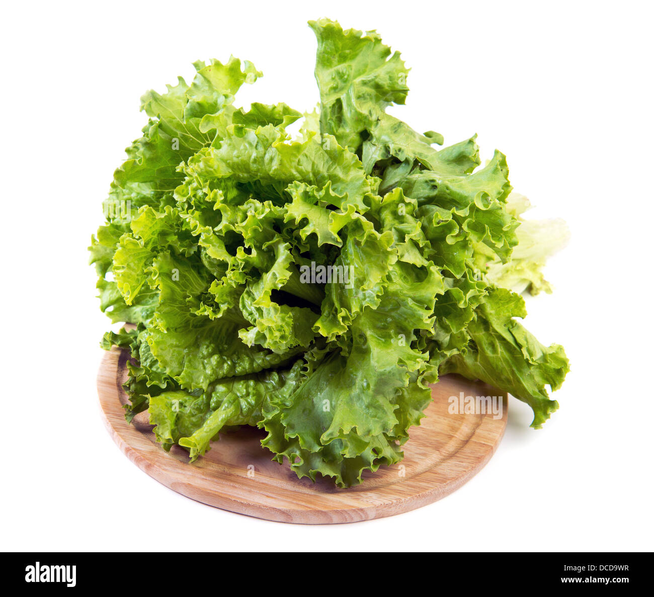 Lettuce leaves on chopping board over white background Stock Photo
