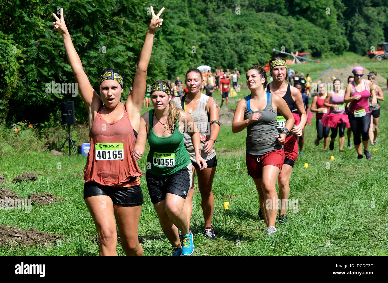 Racers competing in Mud run race Stock Photo Alamy