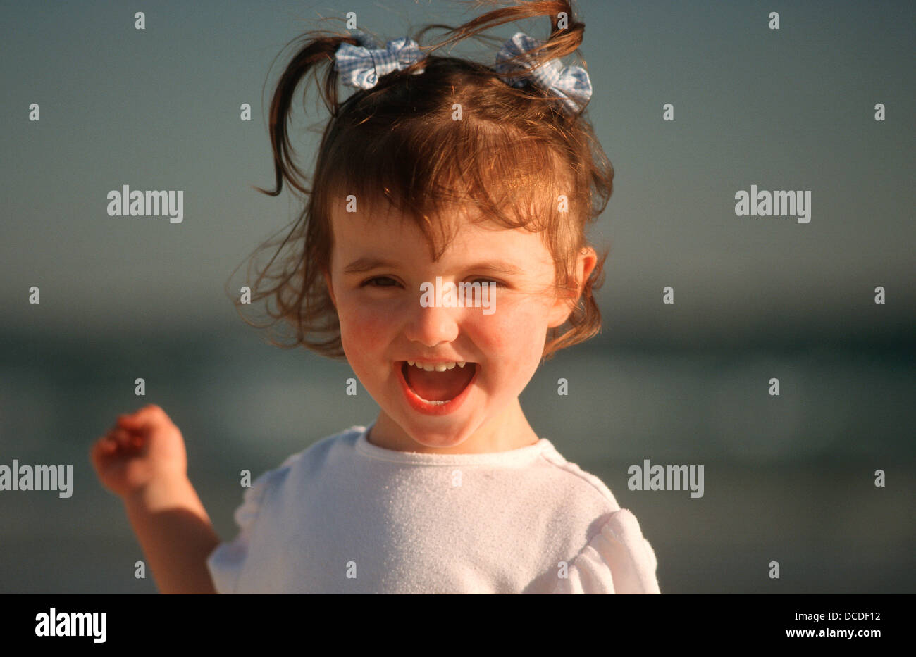 Young girl playing on beach Stock Photo - Alamy