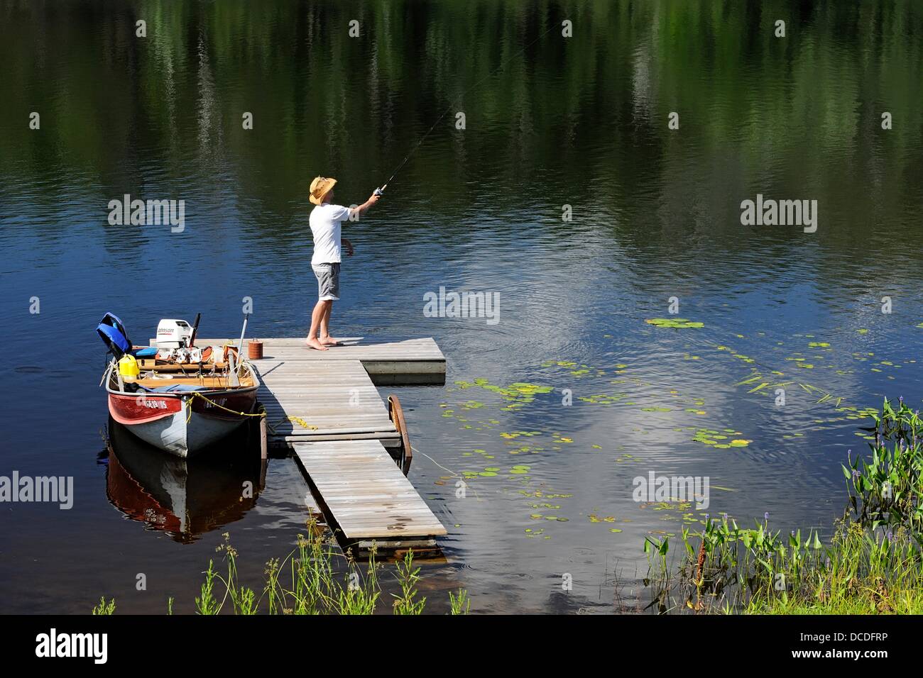 Still fishing from a dock in Elbow Lake Stock Photo
