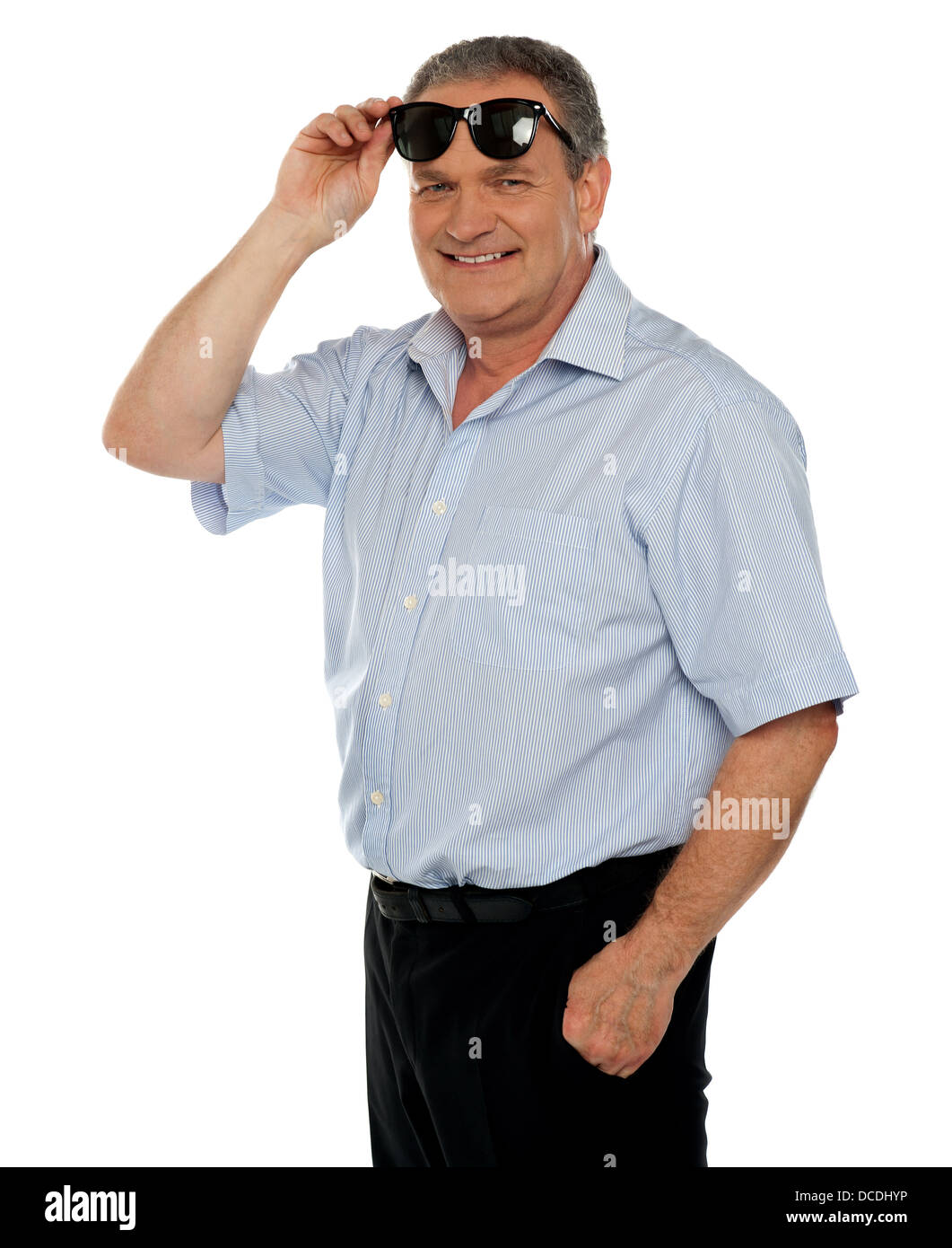 Casual man holding sunglasses over his head smiling at you Stock Photo ...