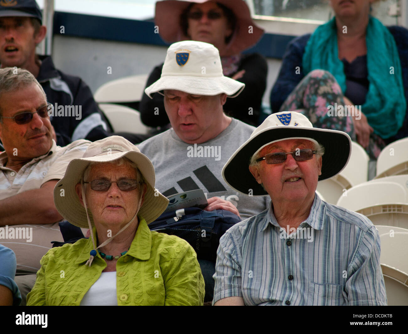 Cricket fans on a sunny day,sitting up in the stands at Sussex Stock Photo