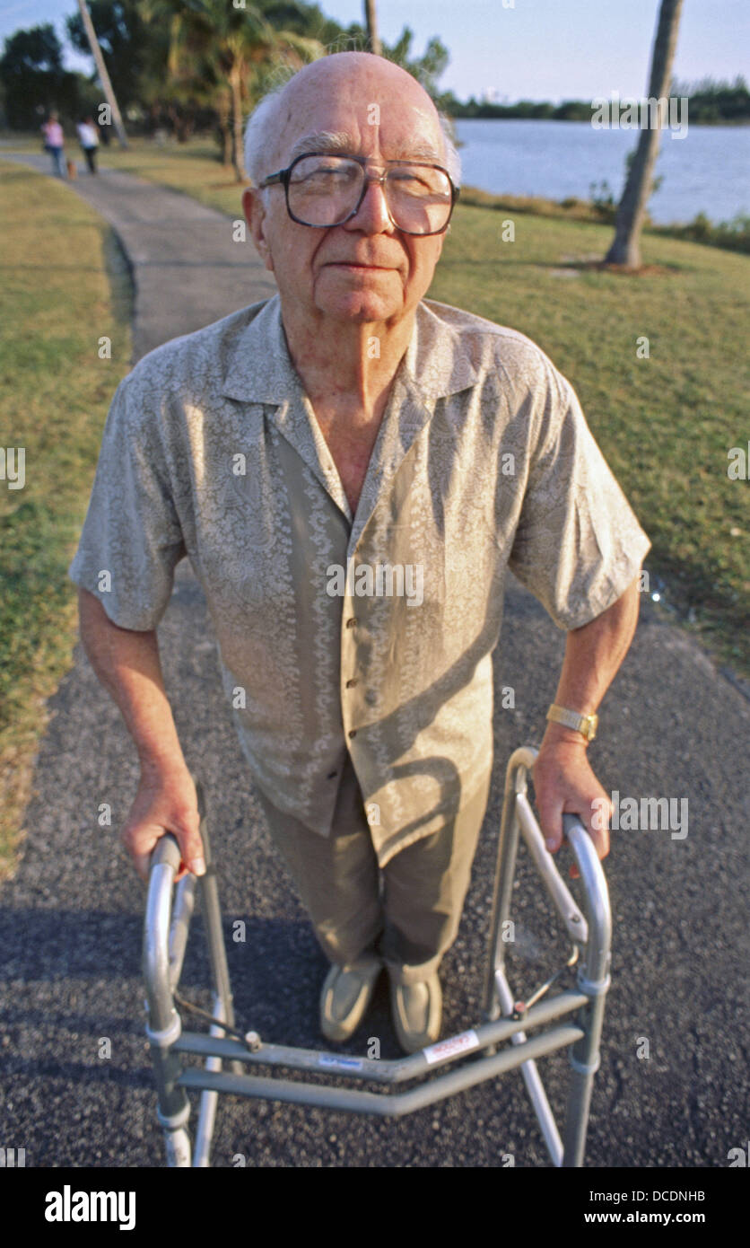Senior walking with walker Stock Photo - Alamy