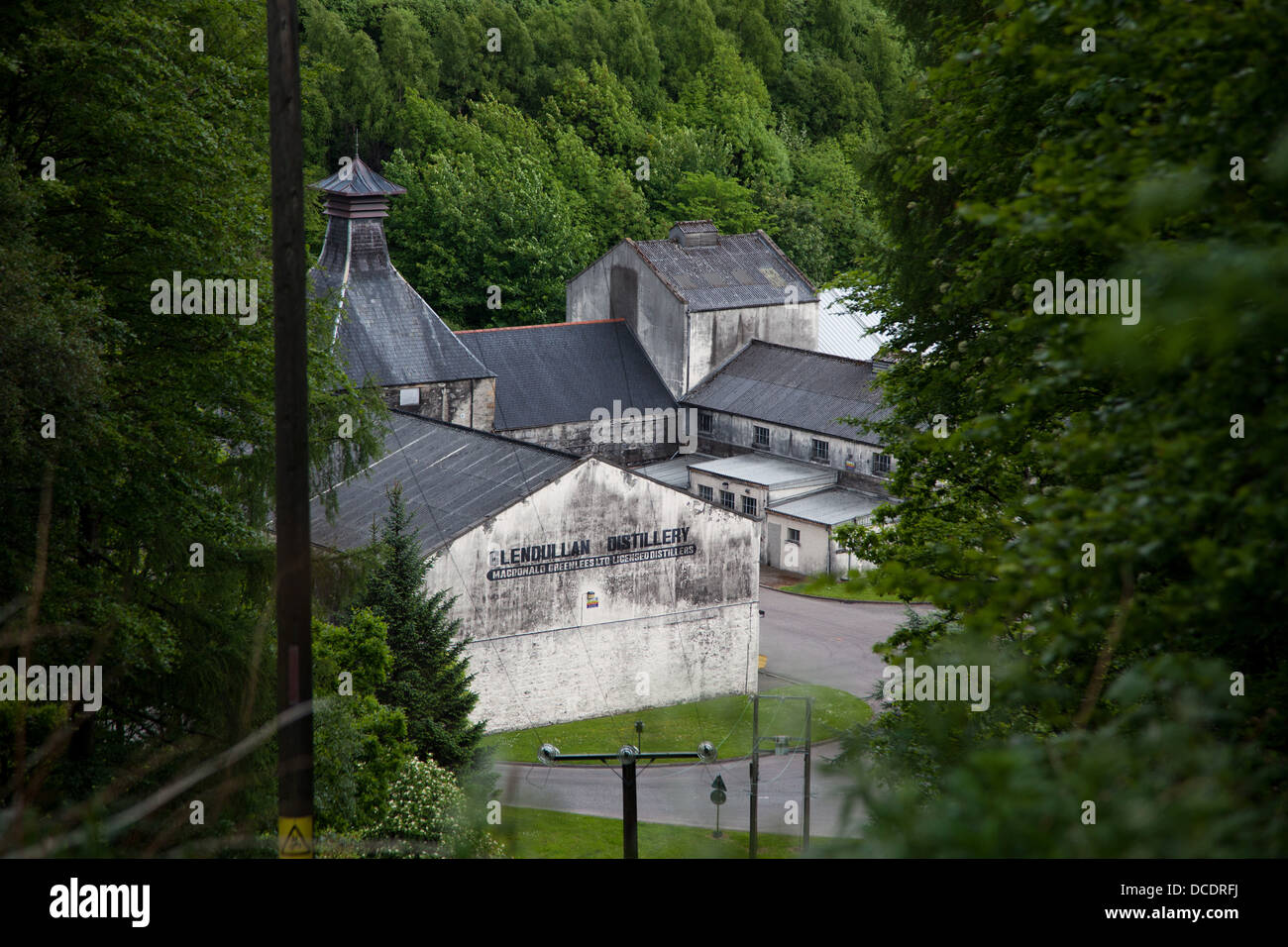 The distillery Glendullan lies surrounded by trees and hills in Dufftown in the Scottish Highlands. Stock Photo