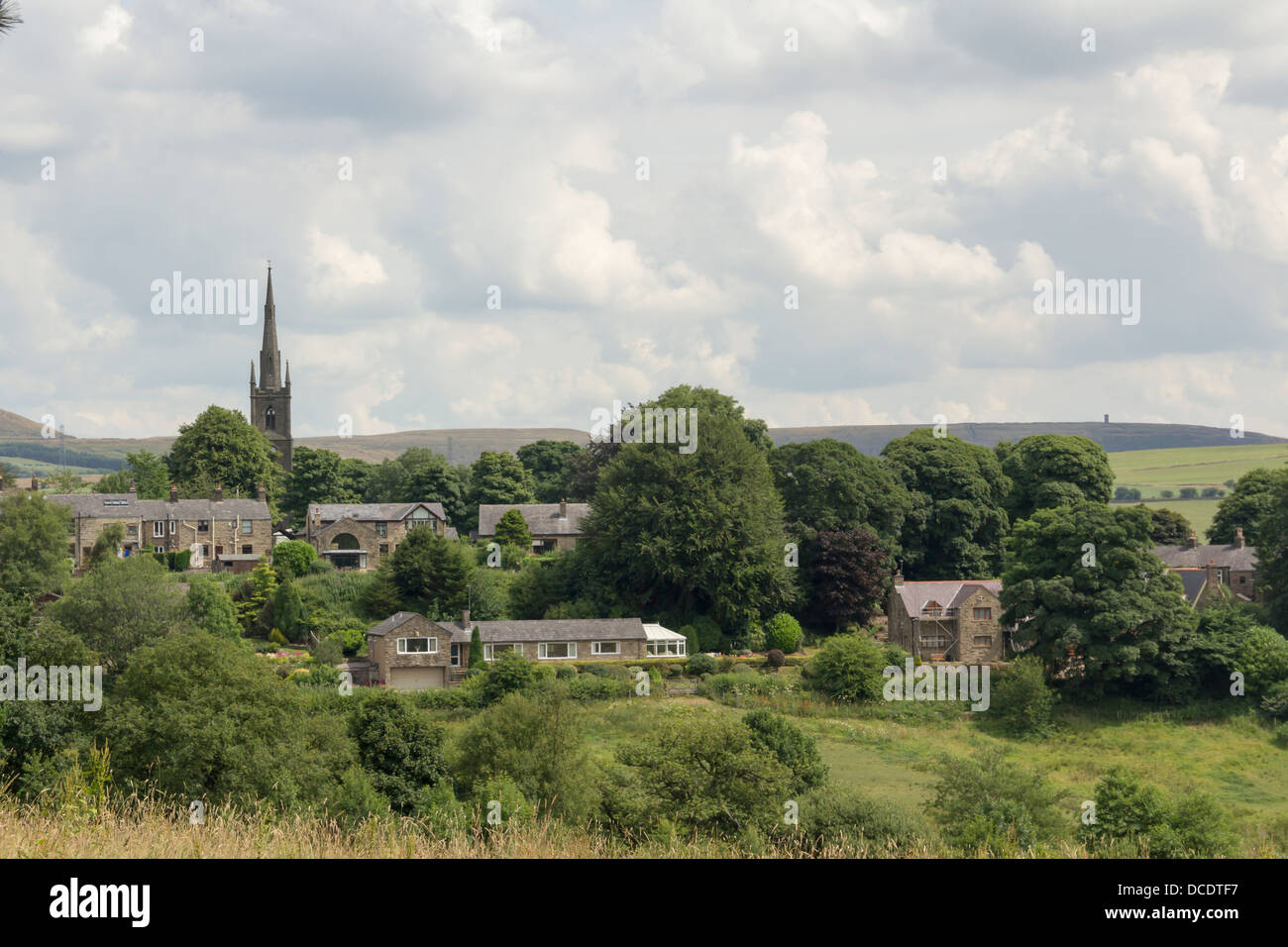 The village of Chapeltown near Bolton in Lancashire with the spire of St. Anne's Church. Beyond the village lies Holcombe Moor. Stock Photo