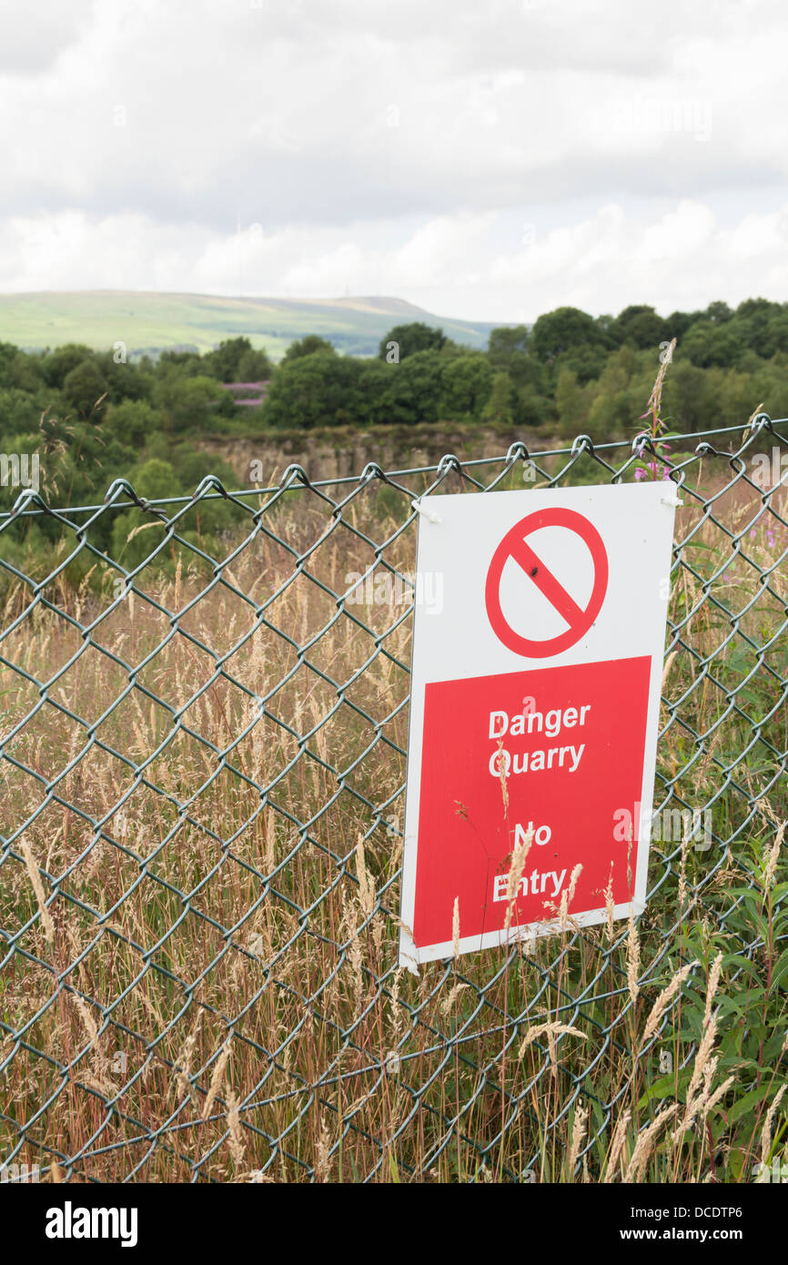 Danger sign at the perimeter fence of the disused Cox Green Quarry at Egerton near Bolton