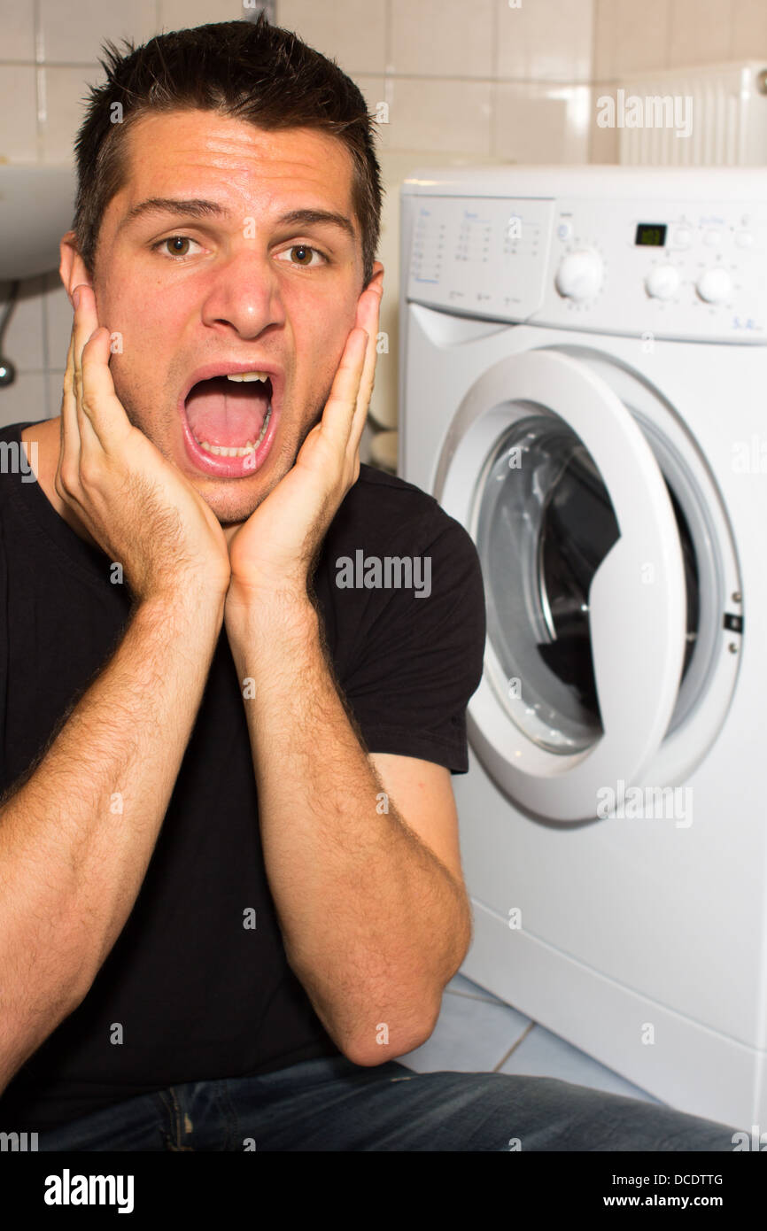 Man screaming at washing machine Stock Photo Alamy