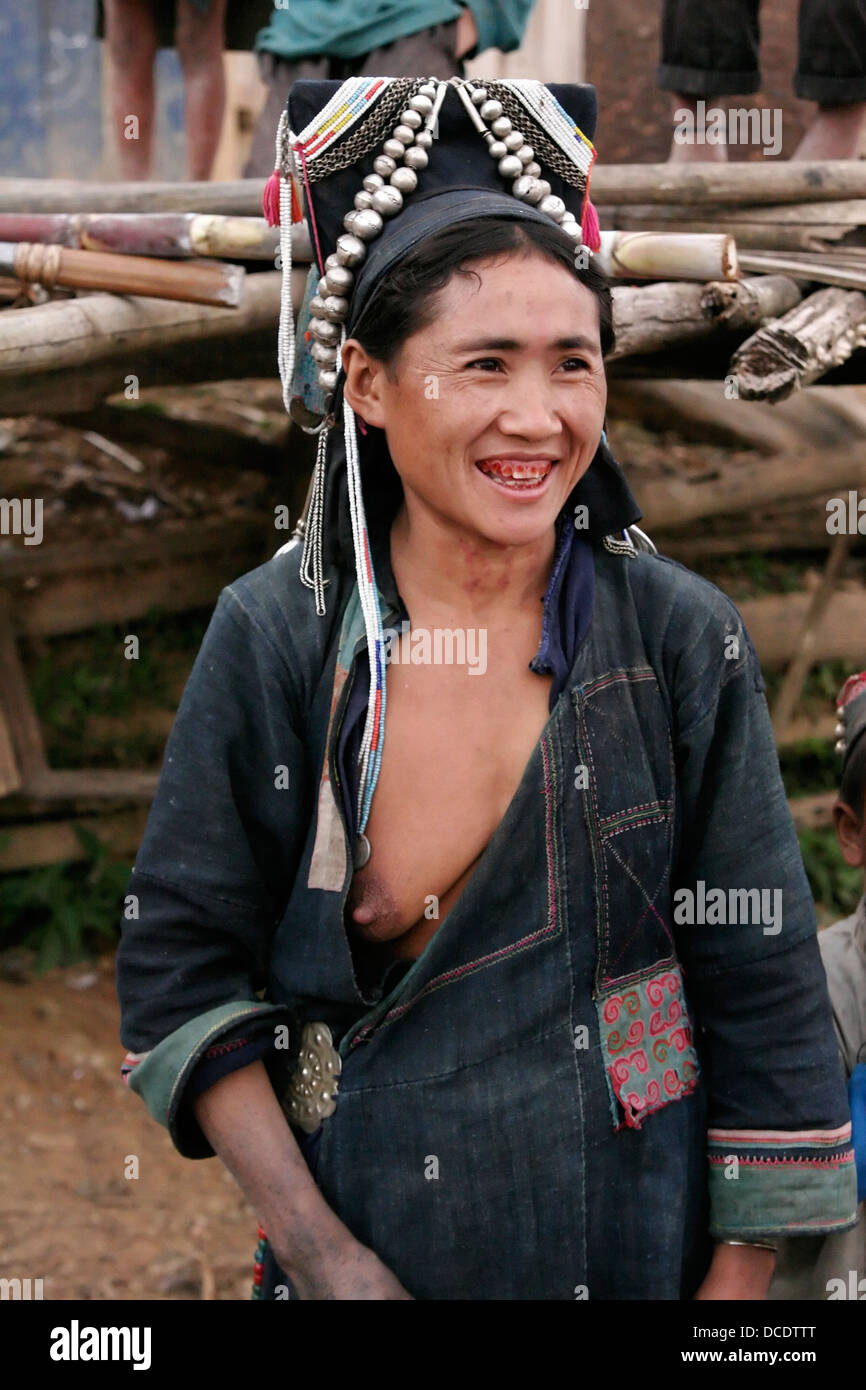 Ethnic Akha woman with exposed breast in tribal village near Phongsali, Laos Stock Photo