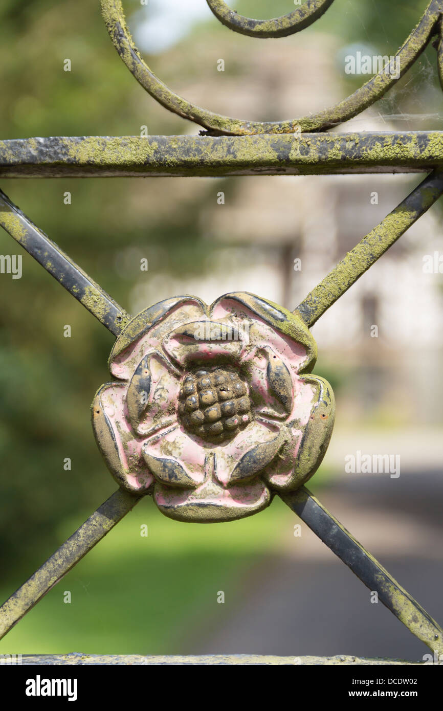 The red rose of Lancashire, weathered, lichen encrusted, on the wrought iron south gate of Turton Tower, Chapeltown, Lancashire. Stock Photo