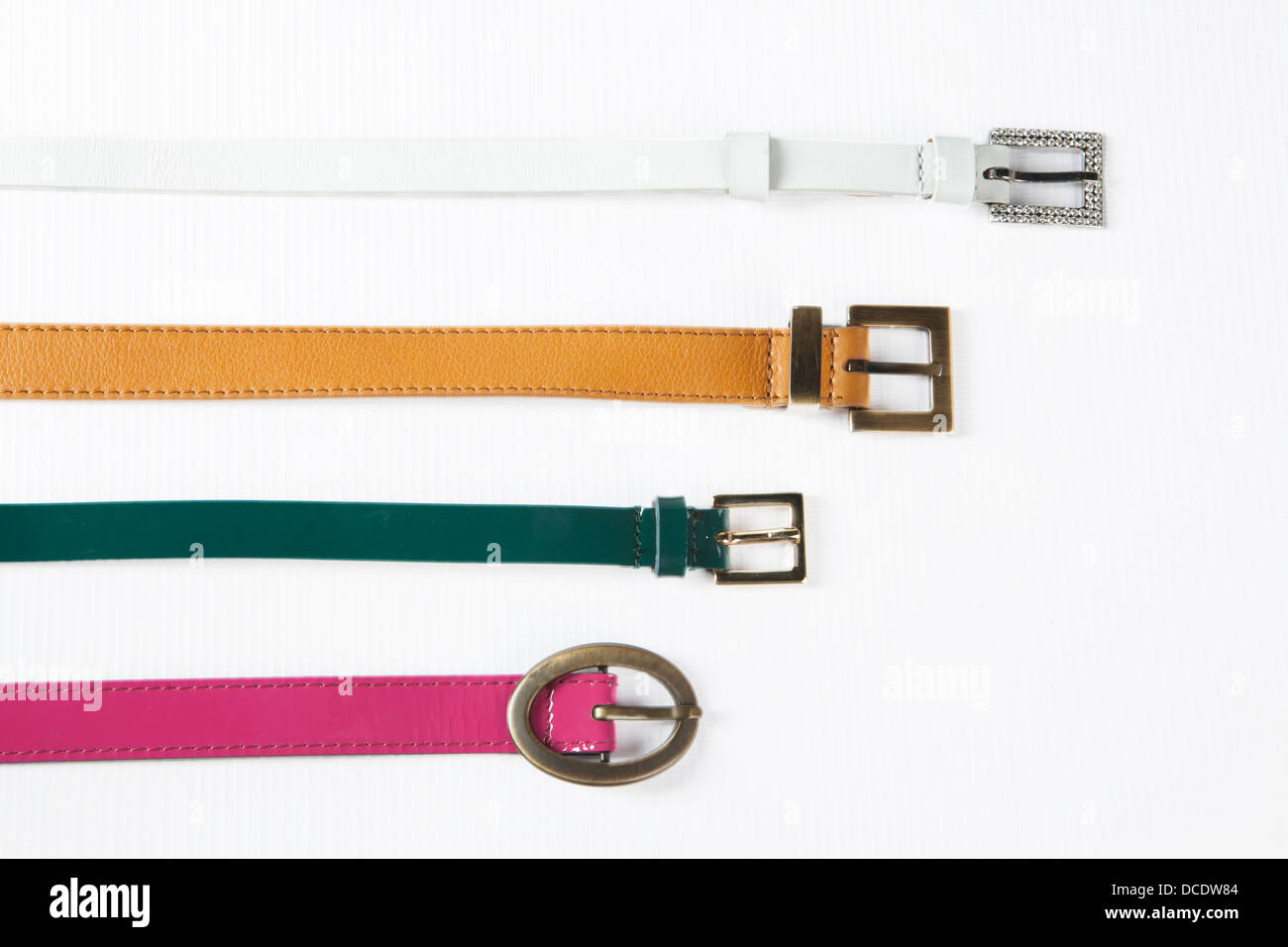 Belts. Set of different leather belts on white background Stock Photo
