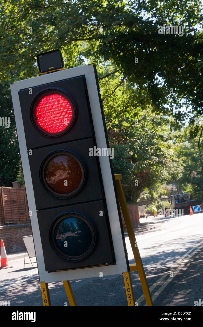 Temporary traffic lights at roadworks showing a red light Stock Photo Alamy