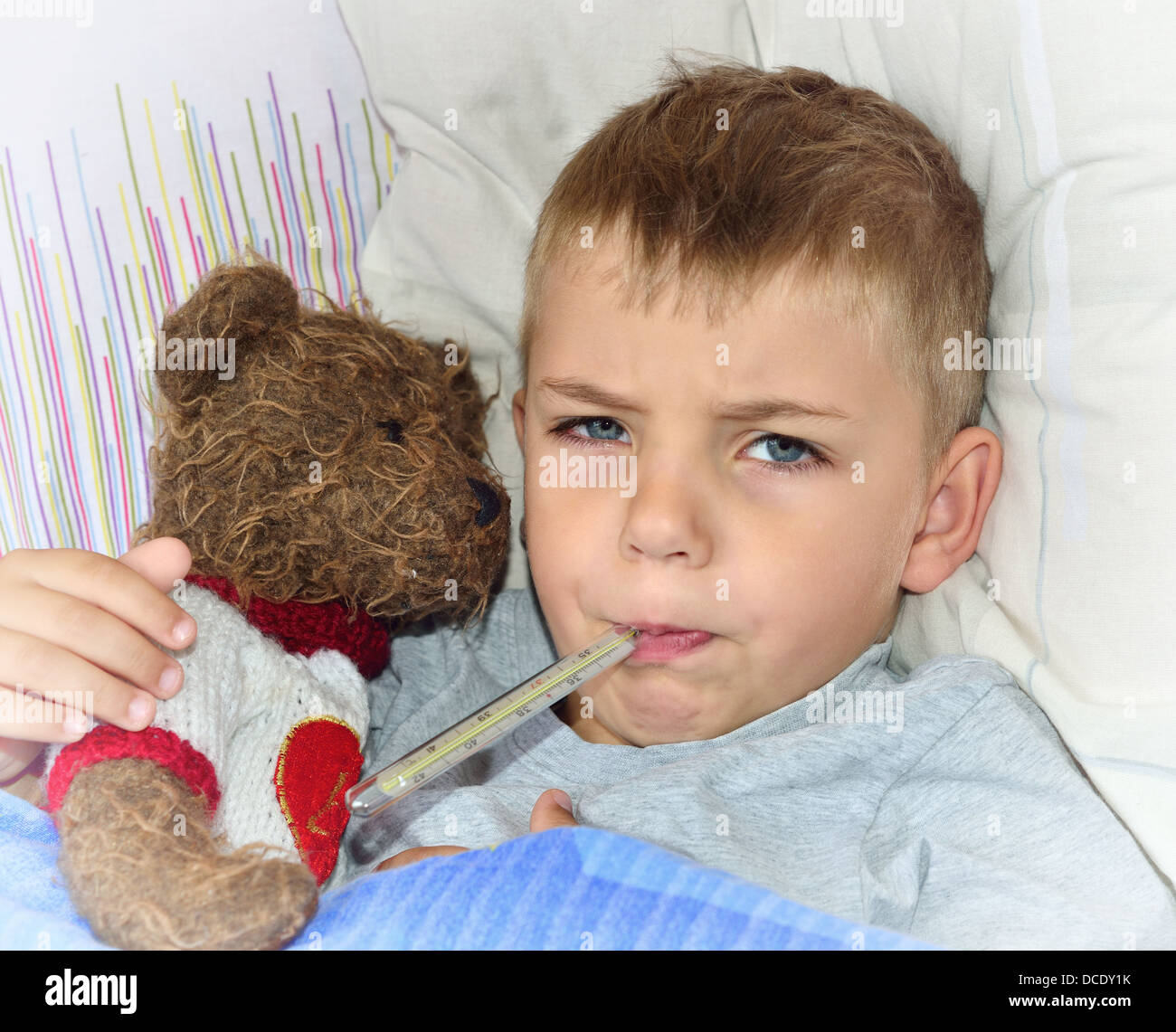 Little sick boy lying in bed with fever Stock Photo Alamy