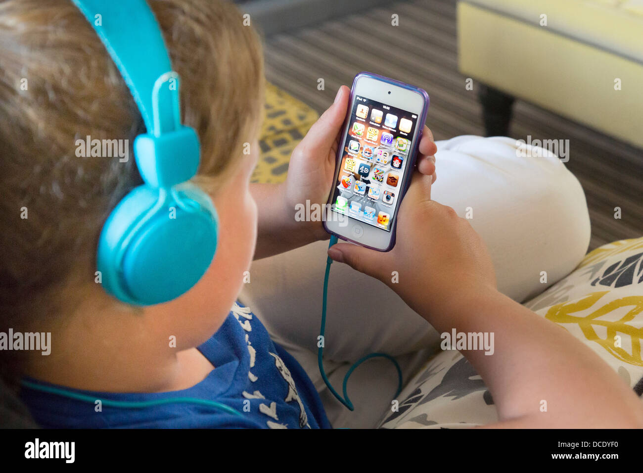 young girl listening to music on iphone smartphone Stock Photo