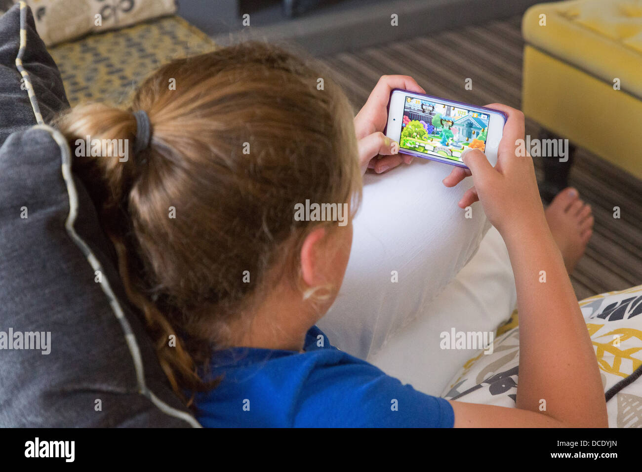 young girl playing game on her smartphone Stock Photo