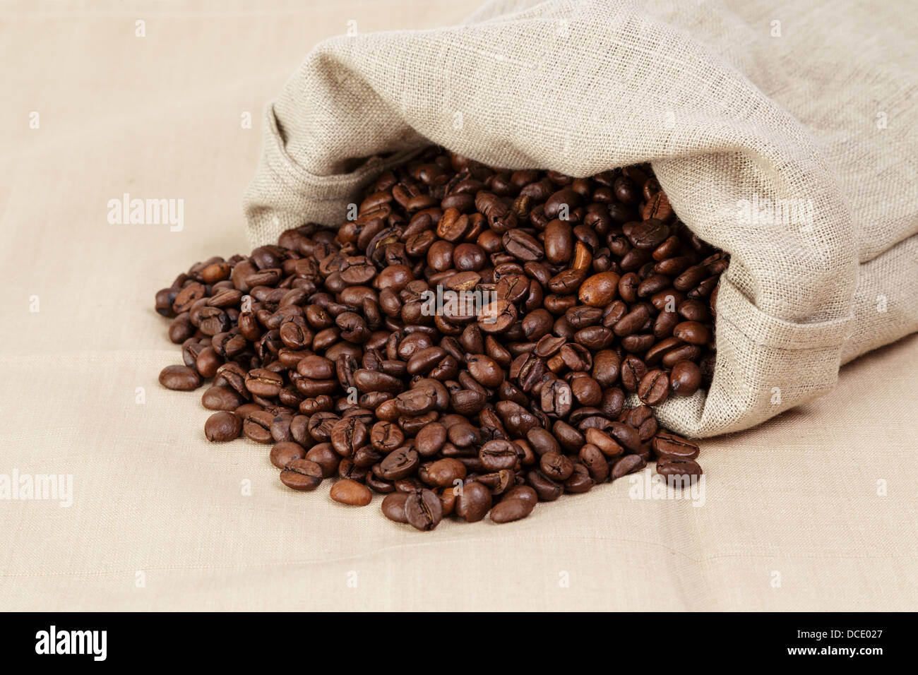 roasted coffee beans spill out of the bag, textile Stock Photo